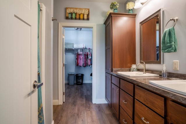 1320 Whiting Rd NW Unit 71, Bemidji, MN 56601 - full bathroom with double vanity, wood finished floors, a spacious closet, and baseboards