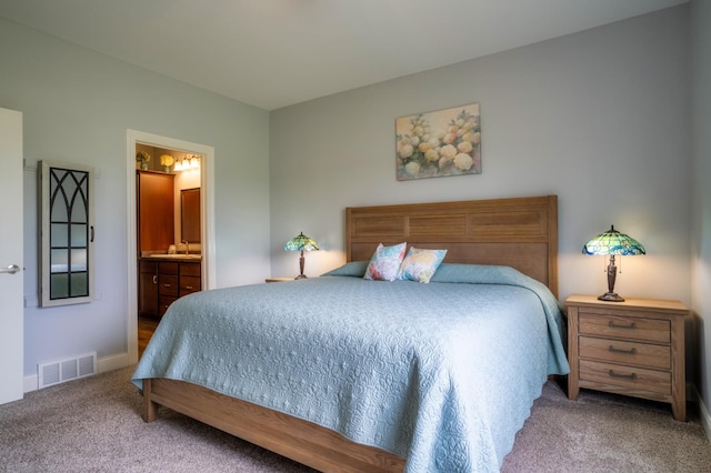1320 Whiting Rd NW Unit 71, Bemidji, MN 56601 - carpeted bedroom featuring ensuite bathroom and baseboards