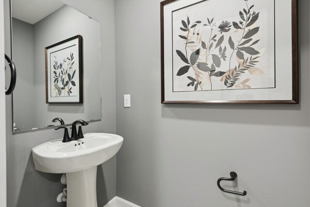 14964 Gibbon Ter NW, Ramsey, MN 55303 - bathroom featuring baseboards