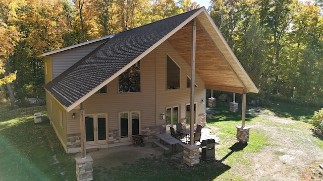4251 Sugar Pt, Orr, MN 55771 - back of house with french doors, a patio area, stone siding, and a yard
