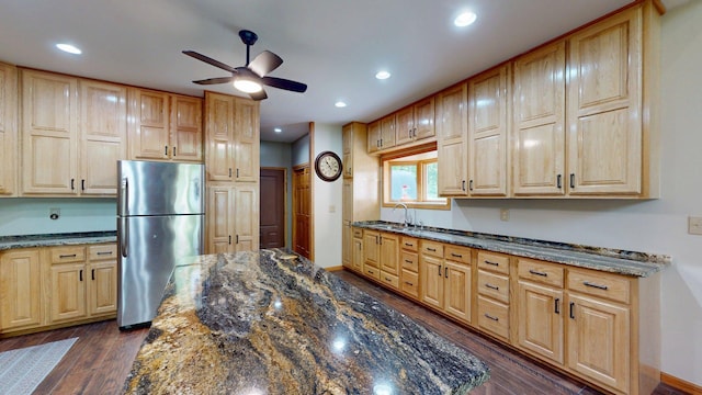 4251 Sugar Pt, Orr, MN 55771 - kitchen featuring freestanding refrigerator, ceiling fan, a sink, dark wood-style flooring, and dark stone countertops
