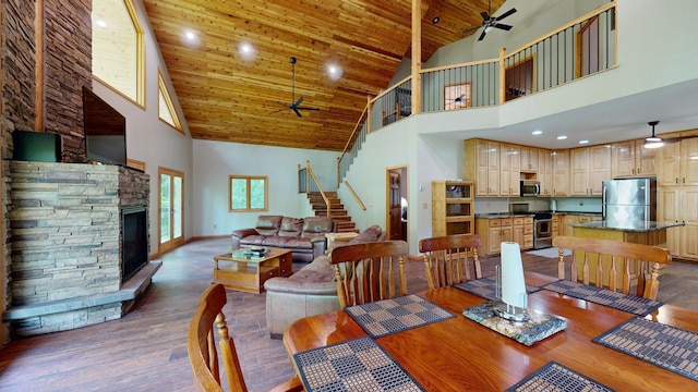 4251 Sugar Pt, Orr, MN 55771 - dining space with a ceiling fan, high vaulted ceiling, dark wood finished floors, stairs, and baseboards