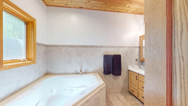 4251 Sugar Pt, Orr, MN 55771 - full bathroom featuring vanity, a whirlpool tub, wooden ceiling, tile patterned flooring, and tile walls
