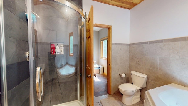 4251 Sugar Pt, Orr, MN 55771 - full bath featuring tile walls, toilet, tile patterned floors, and a shower stall