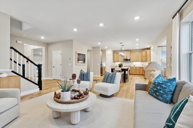 14950 144th Ave N, Dayton, MN 55327 - living area with light wood finished floors, stairway, recessed lighting, and baseboards