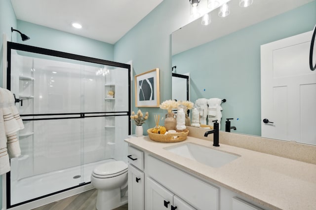14950 144th Ave N, Dayton, MN 55327 - full bathroom featuring toilet, a shower stall, vanity, and wood finished floors