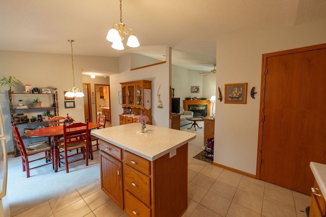 2842 19th Ave NW, Rochester, MN 55901 - kitchen with a chandelier, a glass covered fireplace, a center island, and light countertops