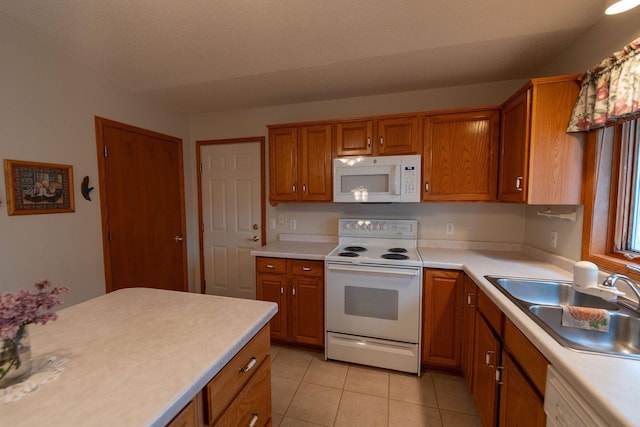 2842 19th Ave NW, Rochester, MN 55901 - kitchen with white appliances, a sink, brown cabinetry, and light countertops