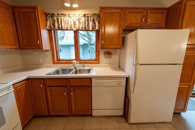 2842 19th Ave NW, Rochester, MN 55901 - kitchen with white appliances, a sink, brown cabinets, and light countertops