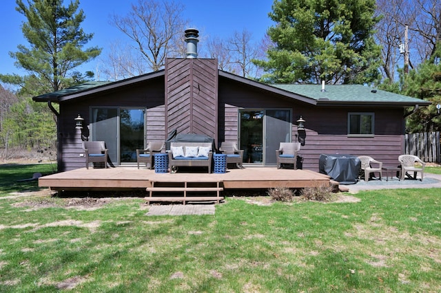 10151 Sandy Beach Rd, Round Lake Twp, WI 54843 - rear view of house with a deck and a chimney