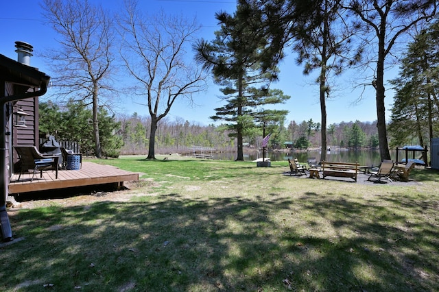 10151 Sandy Beach Rd, Round Lake Twp, WI 54843 - view of grassy yard with a deck with water view