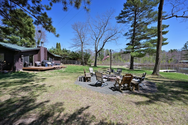 10151 Sandy Beach Rd, Round Lake Twp, WI 54843 - view of grassy yard with a fire pit and a deck with water view