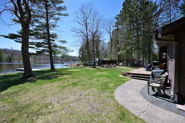 10151 Sandy Beach Rd, Round Lake Twp, WI 54843 - view of green lawn with a deck with water view