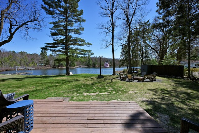 10151 Sandy Beach Rd, Round Lake Twp, WI 54843 - deck featuring a water view, a fire pit, and a yard