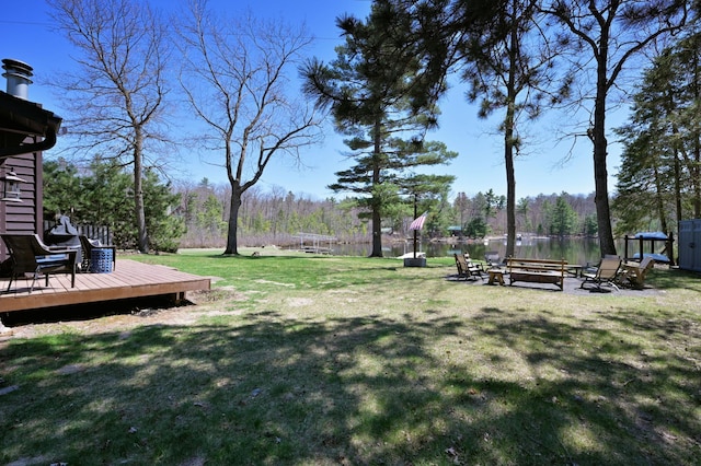 10151 Sandy Beach Rd, Round Lake Twp, WI 54843 - view of green lawn with a deck with water view