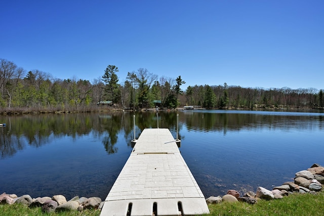 10151 Sandy Beach Rd, Round Lake Twp, WI 54843 - dock area featuring a wooded view and a water view