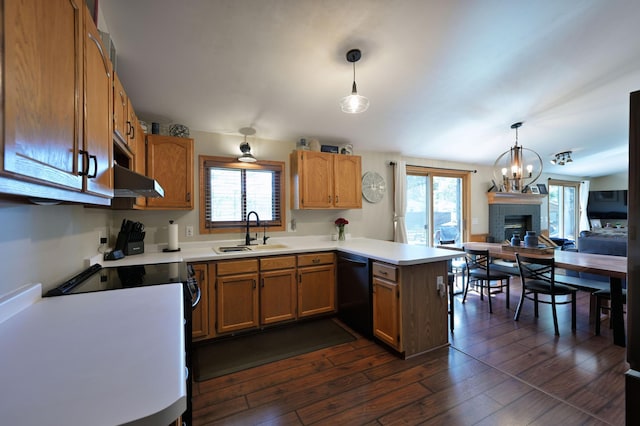 10151 Sandy Beach Rd, Round Lake Twp, WI 54843 - kitchen featuring a sink, a peninsula, black dishwasher, stove, and a fireplace