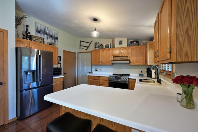 10151 Sandy Beach Rd, Round Lake Twp, WI 54843 - kitchen with stainless steel appliances, a sink, a peninsula, light countertops, and under cabinet range hood