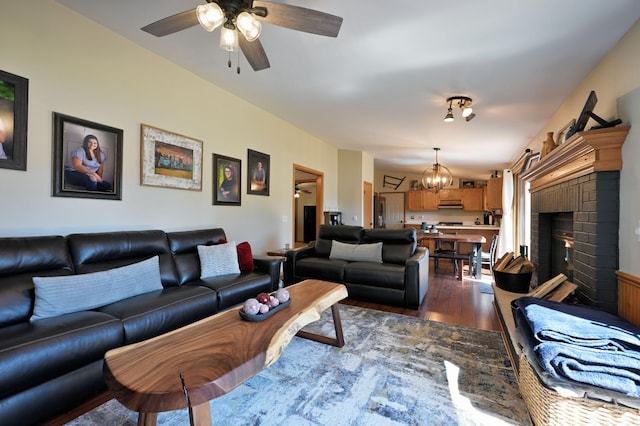 10151 Sandy Beach Rd, Round Lake Twp, WI 54843 - living room featuring dark wood-type flooring, a chandelier, a ceiling fan, and a fireplace