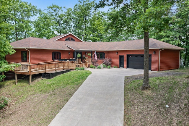 2207 Barron Polk St, Comstock, WI 54826 - view of front of house with an attached garage, driveway, a shingled roof, a porch, and log veneer siding