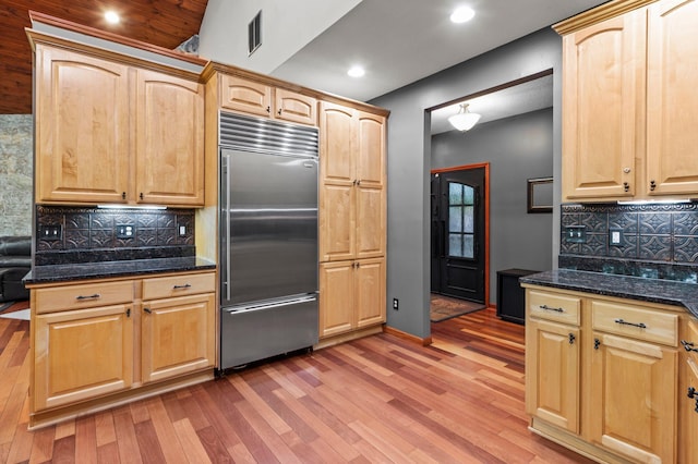 2207 Barron Polk St, Comstock, WI 54826 - kitchen featuring stainless steel built in refrigerator, light wood-style flooring, backsplash, dark stone countertops, and recessed lighting