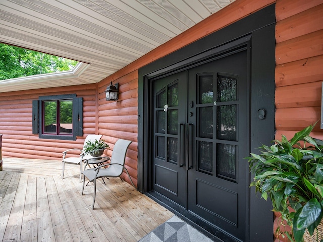 2207 Barron Polk St, Comstock, WI 54826 - entrance to property with french doors, faux log siding, and covered porch