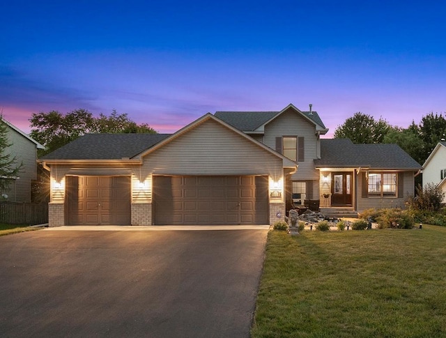 5630 Oak View Ct, Savage, MN 55378 - traditional home featuring asphalt driveway, a lawn, brick siding, and a garage