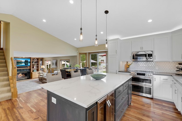 5630 Oak View Ct, Savage, MN 55378 - kitchen with appliances with stainless steel finishes, light wood-style flooring, a center island, beverage cooler, and recessed lighting