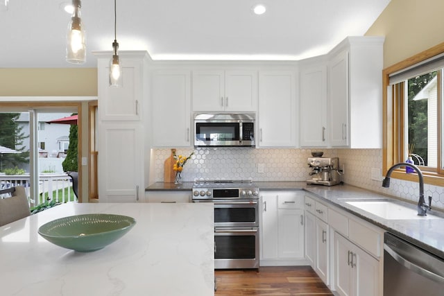 5630 Oak View Ct, Savage, MN 55378 - kitchen with appliances with stainless steel finishes, white cabinets, tasteful backsplash, decorative light fixtures, and recessed lighting