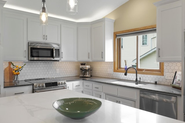 5630 Oak View Ct, Savage, MN 55378 - kitchen featuring stainless steel appliances, decorative backsplash, pendant lighting, and light stone countertops