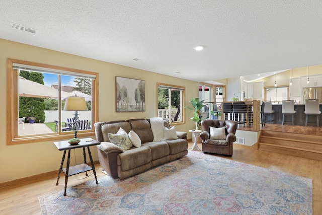 5630 Oak View Ct, Savage, MN 55378 - living area with light wood finished floors, a textured ceiling, and recessed lighting