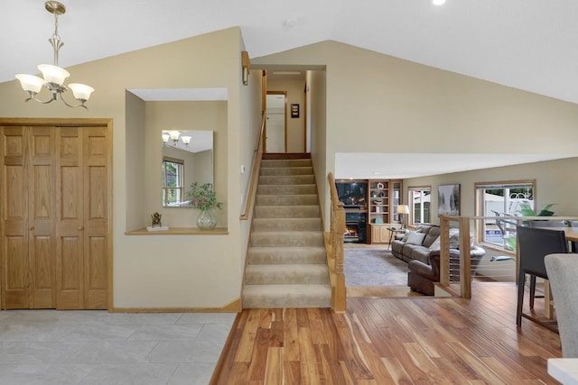 5630 Oak View Ct, Savage, MN 55378 - foyer entrance featuring a chandelier, stairway, high vaulted ceiling, and light wood finished floors