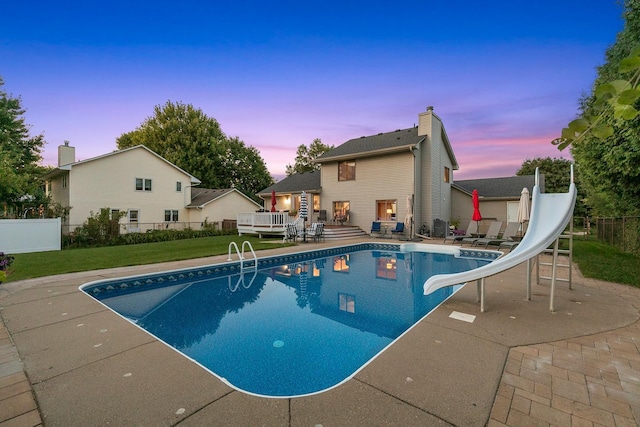 5630 Oak View Ct, Savage, MN 55378 - pool at dusk with a water slide, a patio area, and a deck