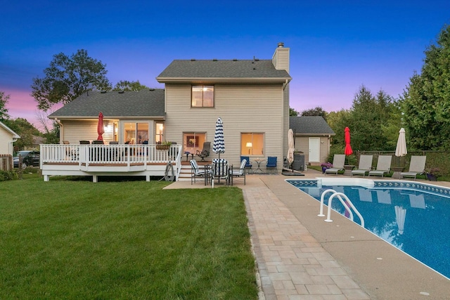 5630 Oak View Ct, Savage, MN 55378 - back of property at dusk featuring a chimney, a lawn, a wooden deck, and a patio