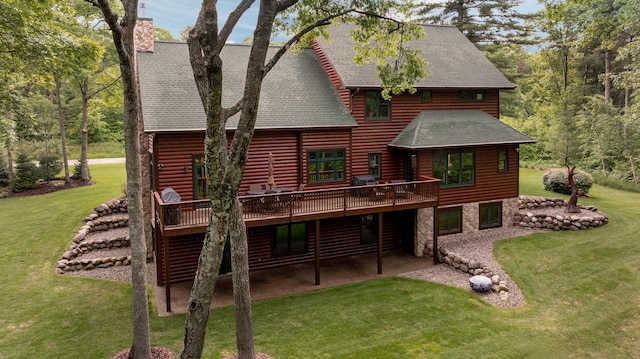 31839 Cree Bay Cir, Pelican Twp, MN 56472 - back of property featuring a wooden deck, a lawn, a shingled roof, a chimney, and a patio area