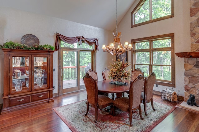 31839 Cree Bay Cir, Pelican Twp, MN 56472 - dining space featuring a chandelier, wood finished floors, high vaulted ceiling, and a textured wall