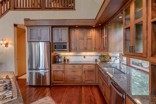 31839 Cree Bay Cir, Pelican Twp, MN 56472 - kitchen with appliances with stainless steel finishes, dark wood-type flooring, brown cabinetry, a sink, and dark stone countertops