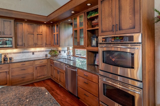 31839 Cree Bay Cir, Pelican Twp, MN 56472 - kitchen with appliances with stainless steel finishes, dark wood-type flooring, dark stone counters, open shelves, and decorative backsplash