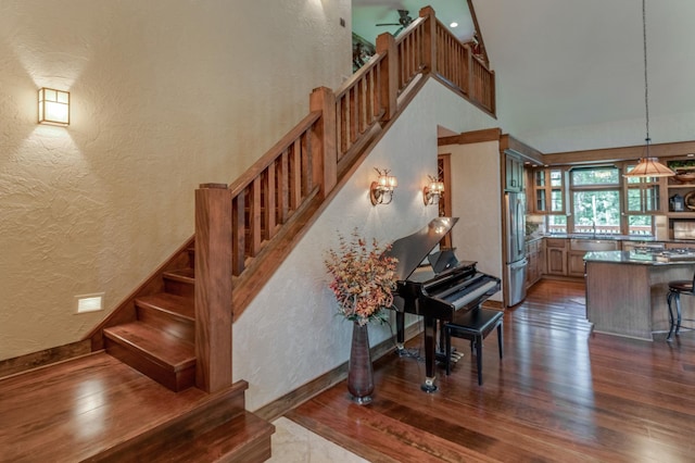 31839 Cree Bay Cir, Pelican Twp, MN 56472 - stairs with a textured wall, wood finished floors, a towering ceiling, baseboards, and ceiling fan
