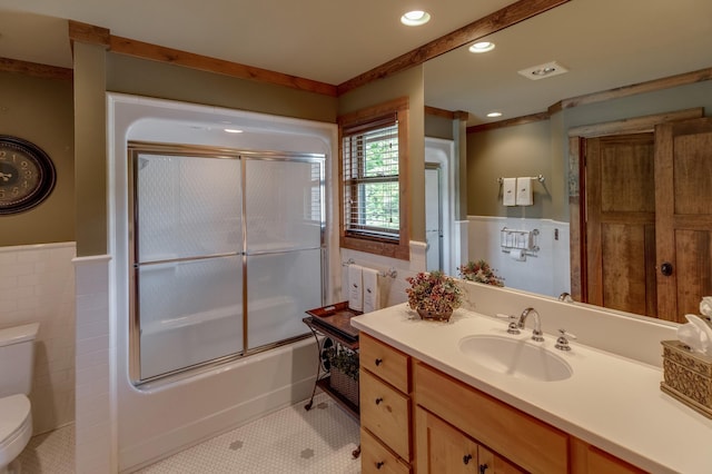 31839 Cree Bay Cir, Pelican Twp, MN 56472 - full bathroom featuring toilet, wainscoting, vanity, shower / bath combination with glass door, and tile walls