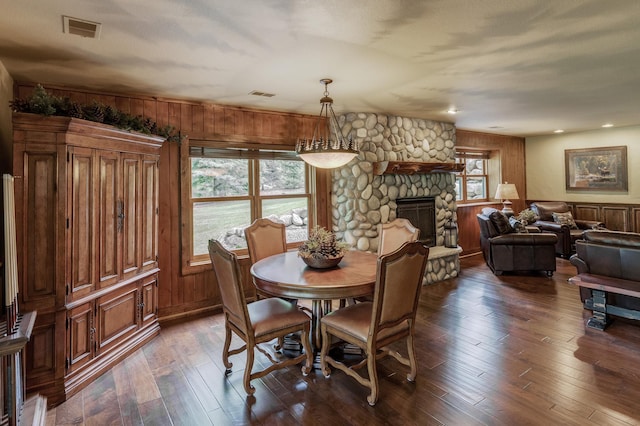 31839 Cree Bay Cir, Pelican Twp, MN 56472 - dining area featuring wood walls, hardwood / wood-style flooring, and a stone fireplace