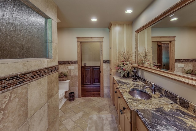 31839 Cree Bay Cir, Pelican Twp, MN 56472 - bathroom with tile walls, vanity, toilet, recessed lighting, and a wainscoted wall