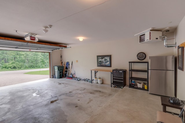 31839 Cree Bay Cir, Pelican Twp, MN 56472 - garage featuring freestanding refrigerator, a garage door opener, and a heating unit