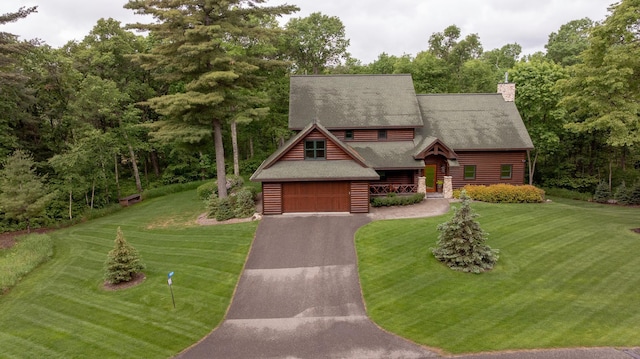 31839 Cree Bay Cir, Pelican Twp, MN 56472 - log-style house featuring a front yard, driveway, a chimney, roof with shingles, and an attached garage