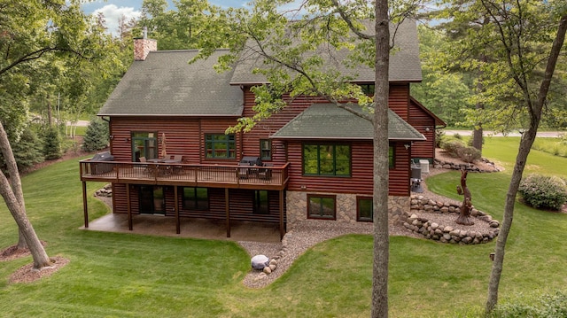 31839 Cree Bay Cir, Pelican Twp, MN 56472 - back of house featuring roof with shingles, a patio area, a deck, a yard, and a chimney