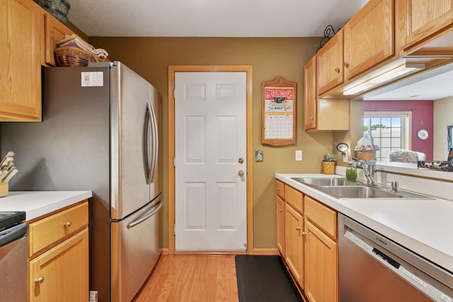 14617 Evergreen Trl Unit 75, Apple Valley, MN 55124 - kitchen with appliances with stainless steel finishes, light wood-style flooring, a sink, and light countertops