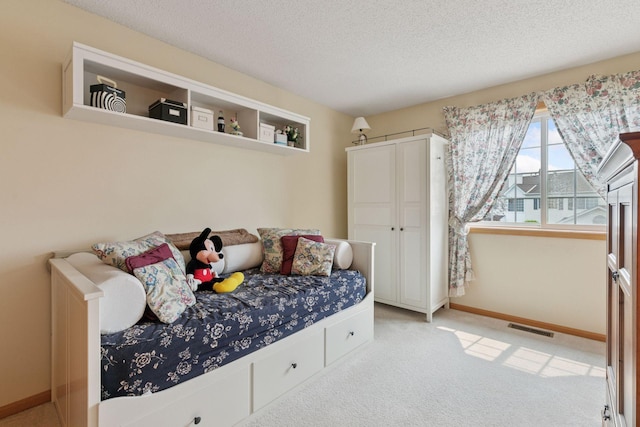 14617 Evergreen Trl Unit 75, Apple Valley, MN 55124 - bedroom featuring light carpet, a textured ceiling, and baseboards