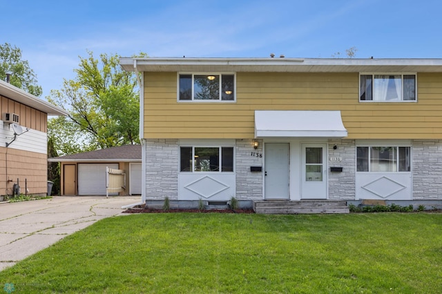 1138 20th St N, Moorhead, MN 56560 - colonial-style house featuring stone siding and a front yard