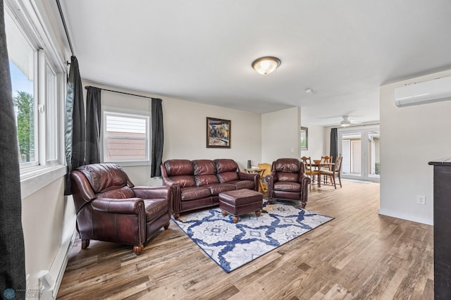 1138 20th St N, Moorhead, MN 56560 - living area featuring a wall mounted air conditioner, wood finished floors, ceiling fan, and baseboards