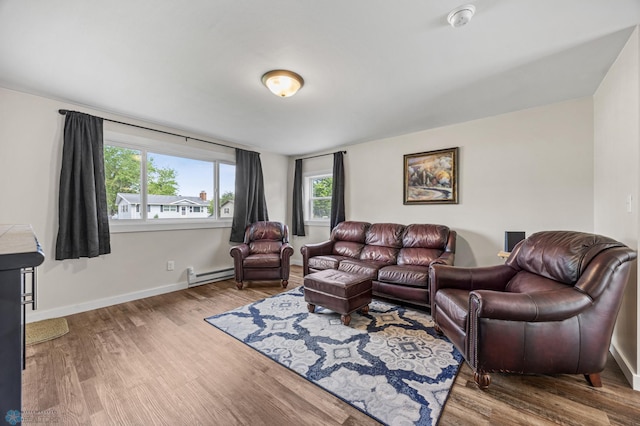1138 20th St N, Moorhead, MN 56560 - living area with a baseboard heating unit, healthy amount of natural light, and wood finished floors